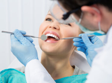 Regular dentist visit. Caries cure. Young woman visiting dentist