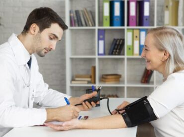 medium-shot-doctor-taking-blood-pressure