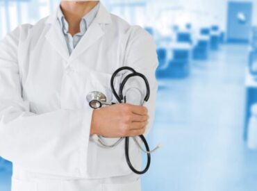 Mid-section of female doctor holding stethoscope in hospital